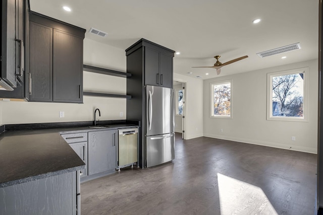 kitchen with appliances with stainless steel finishes, ceiling fan, and sink