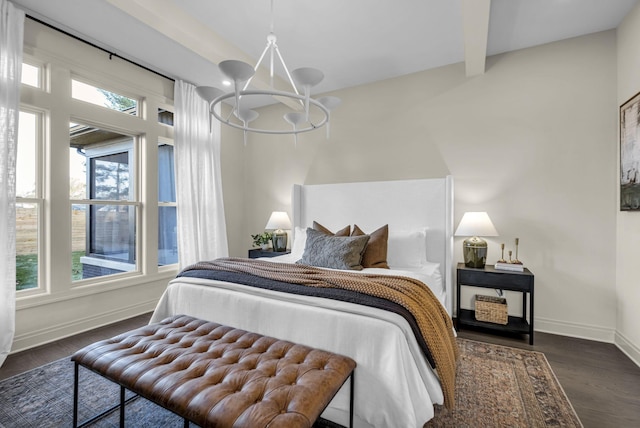 bedroom with a chandelier, beamed ceiling, and dark hardwood / wood-style floors