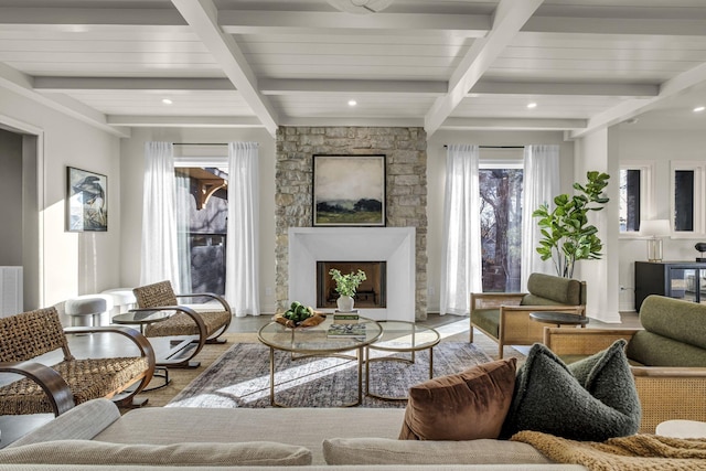 living room featuring beamed ceiling and a fireplace