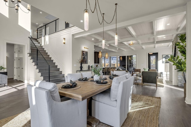 dining room with coffered ceiling, beamed ceiling, and dark wood-type flooring