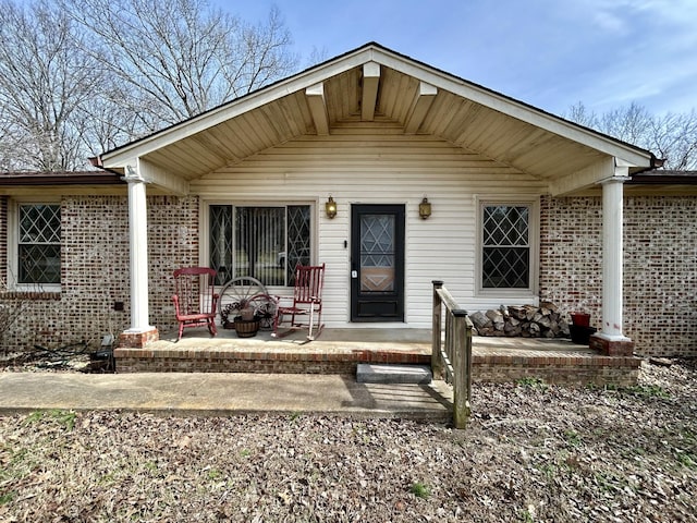 view of front of house with a patio and brick siding