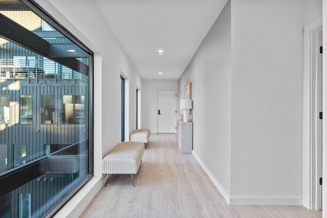 hallway with light hardwood / wood-style floors