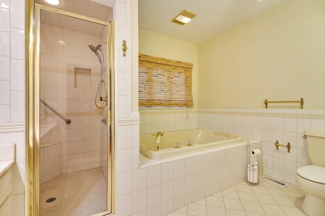 full bathroom featuring tile patterned floors, toilet, tile walls, shower with separate bathtub, and vanity