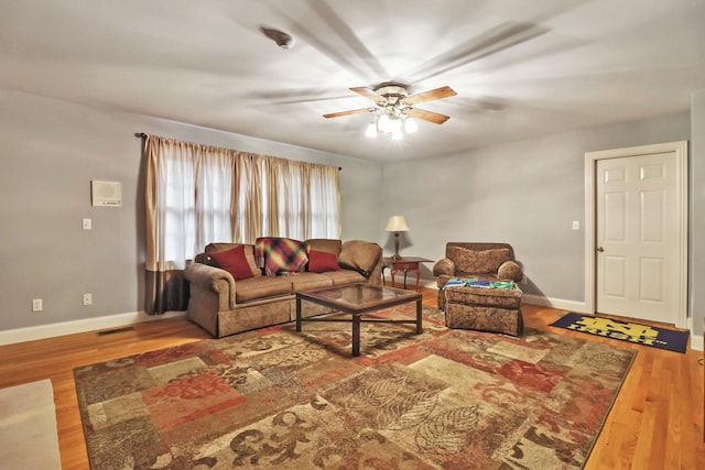 living room featuring ceiling fan and wood-type flooring