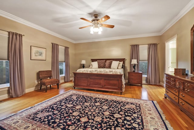 bedroom with light hardwood / wood-style floors, ceiling fan, and ornamental molding