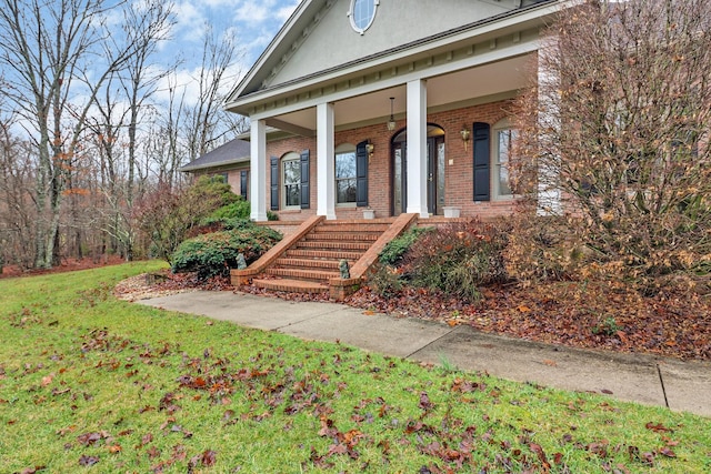 view of front of house with covered porch and a front yard