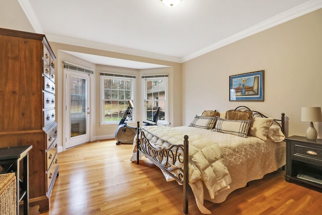 bedroom featuring access to outside, crown molding, and light hardwood / wood-style floors