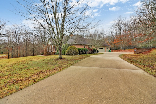 view of front of home featuring a front lawn and a garage