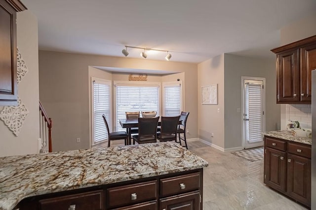 306 Amherst Dr, Tullahoma, TN 37388 - kitchen with dark brown cabinets and light stone countertops
