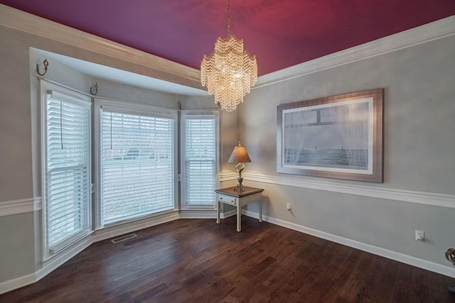 306 Amherst Dr, Tullahoma, TN 37388 - empty room featuring a chandelier, wood finished floors, baseboards, healthy amount of natural light, and crown molding