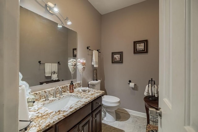 306 Amherst Dr, Tullahoma, TN 37388 - bathroom featuring vanity, toilet, and baseboards