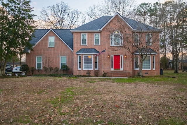 colonial inspired home featuring a lawn