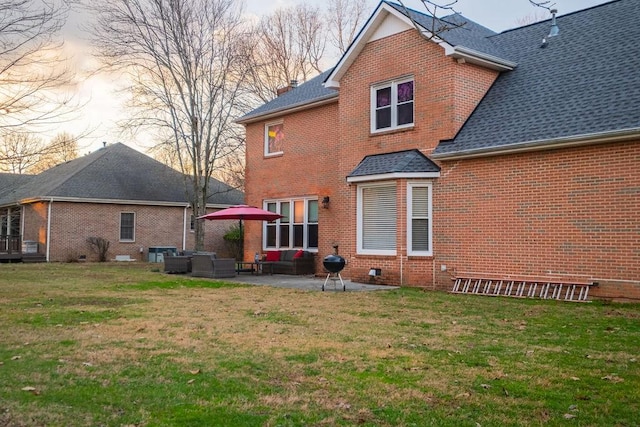 306 Amherst Dr, Tullahoma, TN 37388 - back of house with an outdoor living space, brick siding, a patio, and a lawn