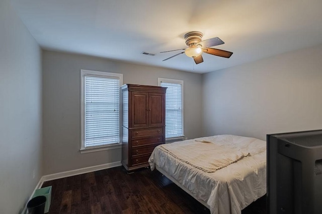 306 Amherst Dr, Tullahoma, TN 37388 - bedroom featuring multiple windows, dark wood finished floors, baseboards, and ceiling fan