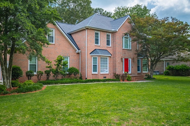 306 Amherst Dr, Tullahoma, TN 37388 - view of front facade featuring a front yard, brick siding, and a shingled roof