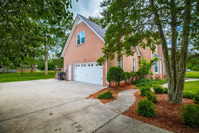 306 Amherst Dr, Tullahoma, TN 37388 - view of front of house featuring concrete driveway, an attached garage, brick siding, and a front lawn