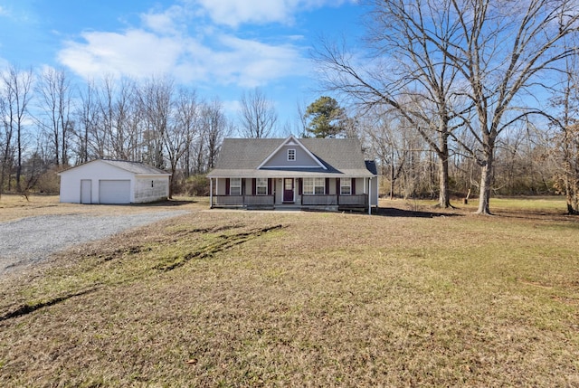 view of front of property with covered porch, a garage, a front yard, and an outdoor structure