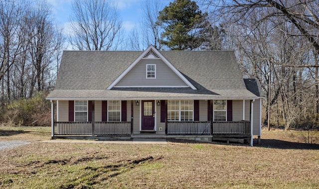 view of front of property featuring covered porch and a front yard