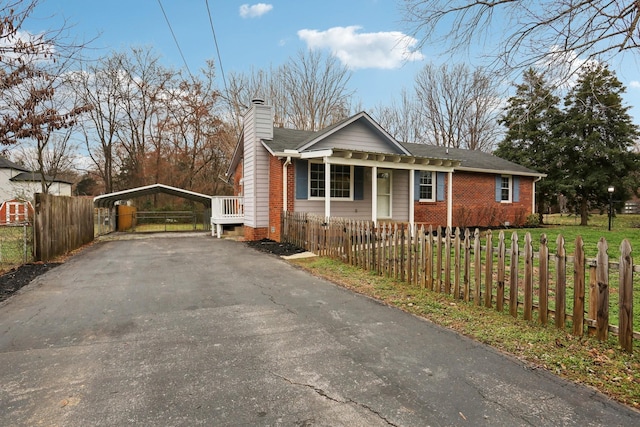 view of front facade with a front lawn and a carport