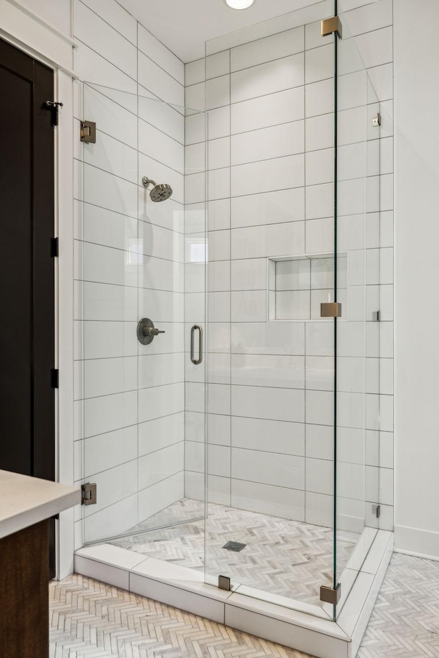 bathroom featuring a shower with shower door