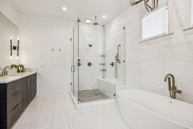 bathroom with tile walls, plus walk in shower, and vanity