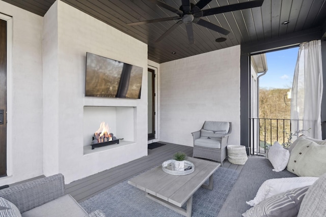 living room with a fireplace, hardwood / wood-style flooring, ceiling fan, and wood ceiling