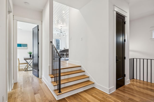 stairway with hardwood / wood-style floors