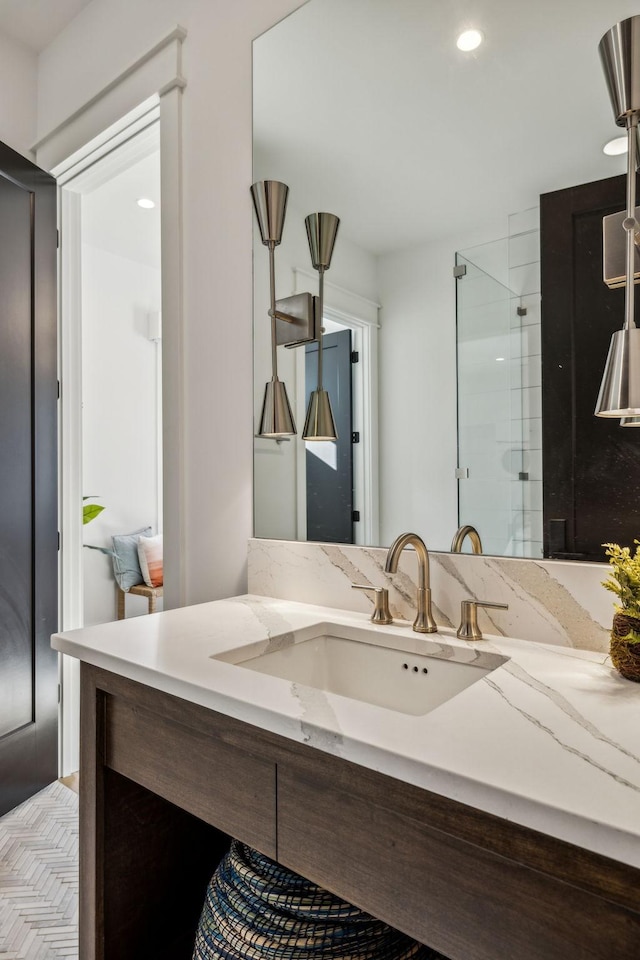 bathroom with an enclosed shower and vanity