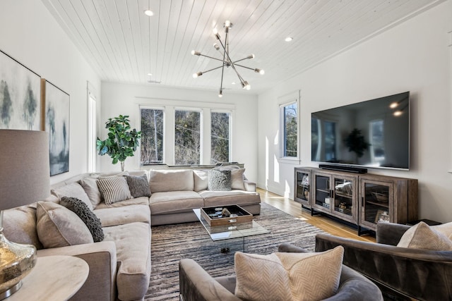 living room featuring hardwood / wood-style flooring, wooden ceiling, and a notable chandelier