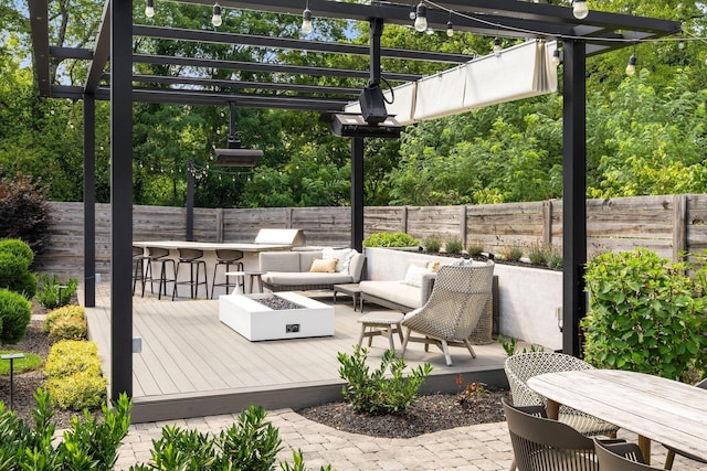 wooden deck featuring an outdoor living space with a fire pit, a pergola, and an outdoor bar