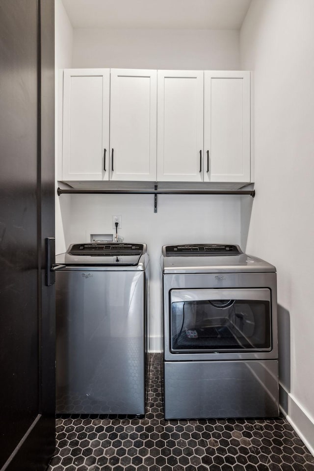 laundry area with cabinets and washing machine and clothes dryer