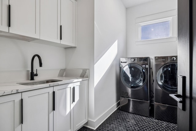 laundry area featuring sink, separate washer and dryer, and cabinets