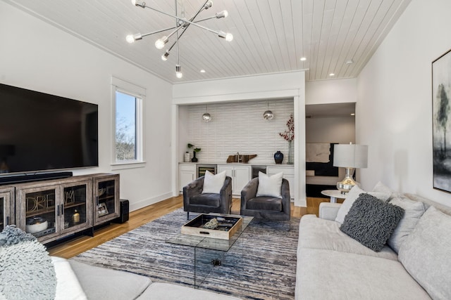 living room featuring light wood-type flooring, an inviting chandelier, and wood ceiling