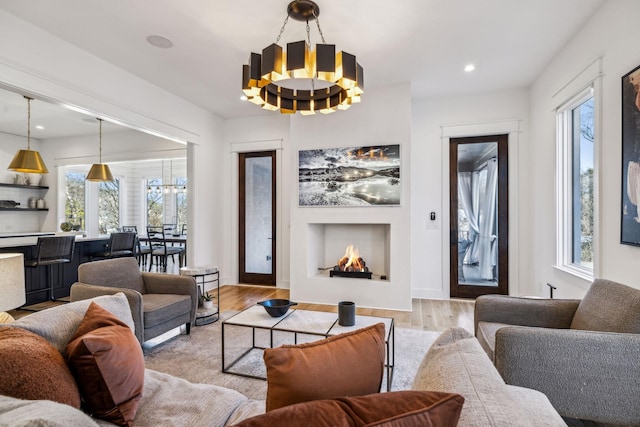 living room featuring light hardwood / wood-style floors and an inviting chandelier