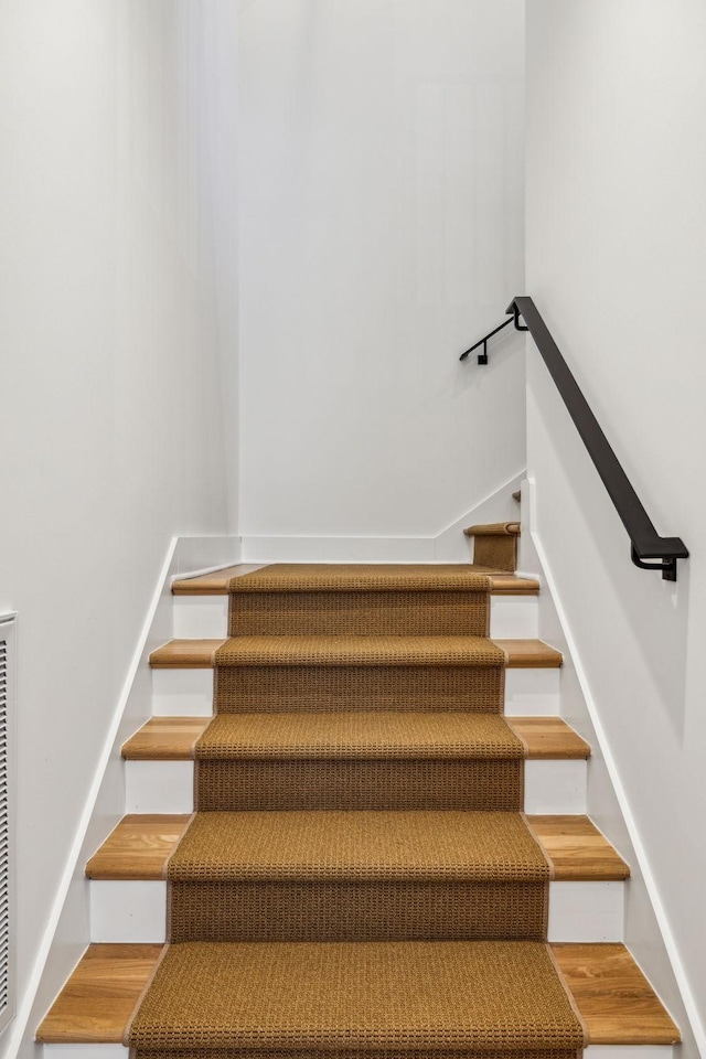 staircase featuring hardwood / wood-style flooring