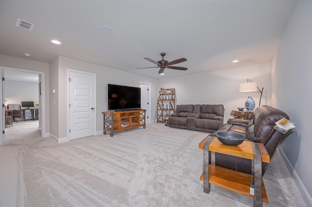 carpeted living room with ceiling fan