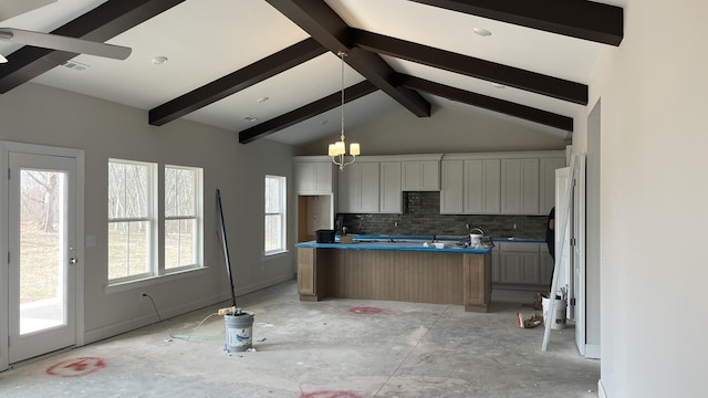 kitchen featuring decorative light fixtures, lofted ceiling with beams, white cabinetry, and backsplash