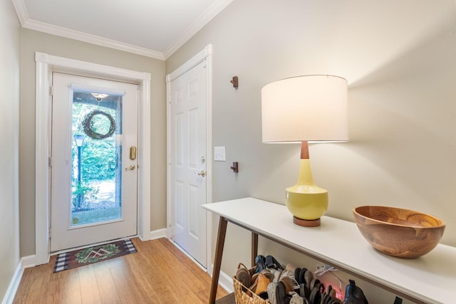 foyer featuring light wood-type flooring and ornamental molding