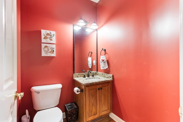 bathroom with toilet and vanity