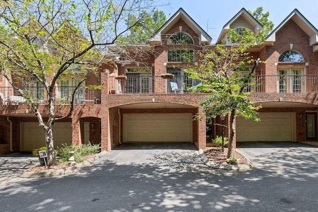 view of front of property with a garage and a balcony