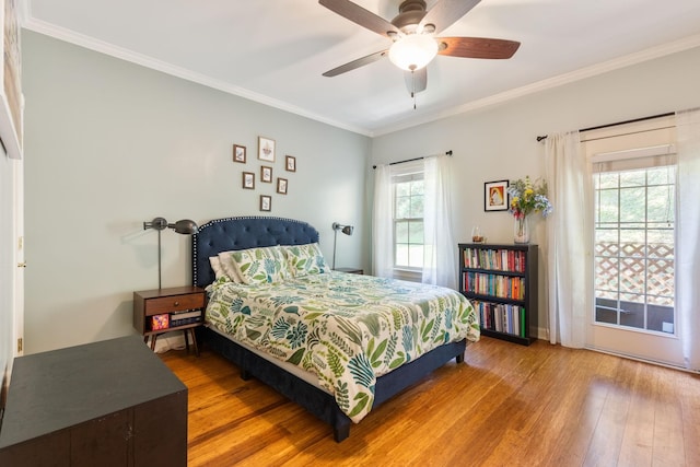 bedroom with hardwood / wood-style floors, ceiling fan, and crown molding