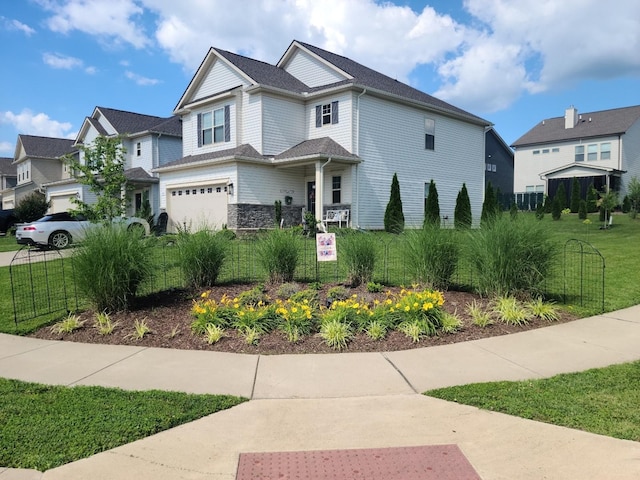 view of front of house featuring a front lawn and a garage