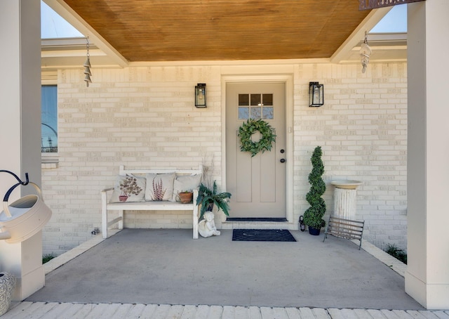 property entrance featuring brick siding