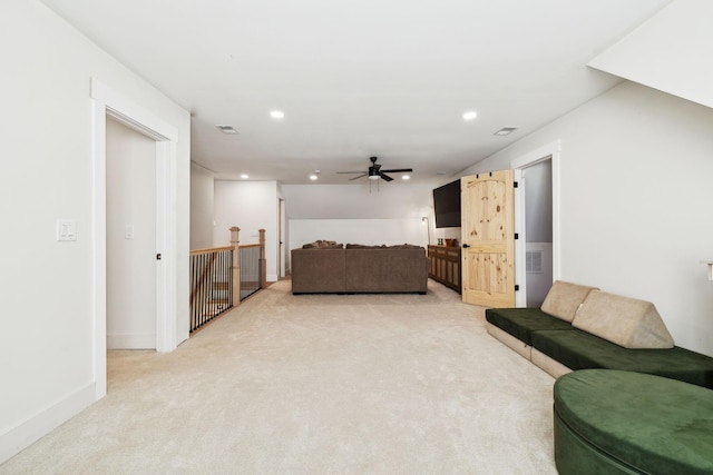 carpeted living room featuring ceiling fan