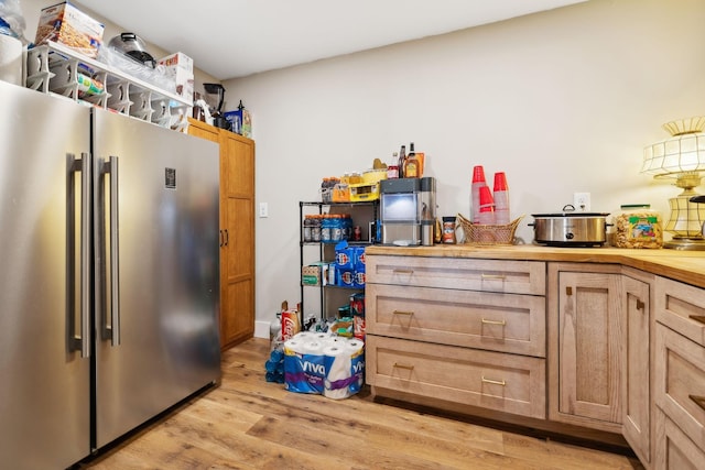 kitchen with light wood-type flooring and stainless steel fridge