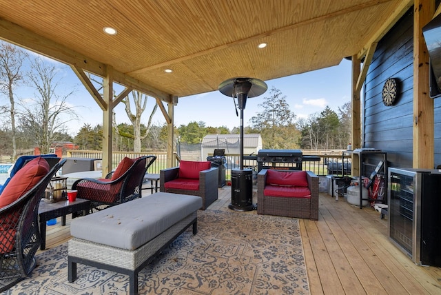 wooden terrace featuring wine cooler and an outdoor hangout area