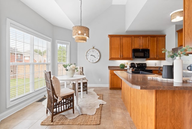 kitchen featuring lofted ceiling, sink, light tile patterned flooring, decorative light fixtures, and black appliances