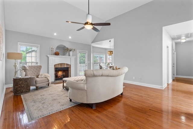 living room featuring high vaulted ceiling, hardwood / wood-style floors, and ceiling fan