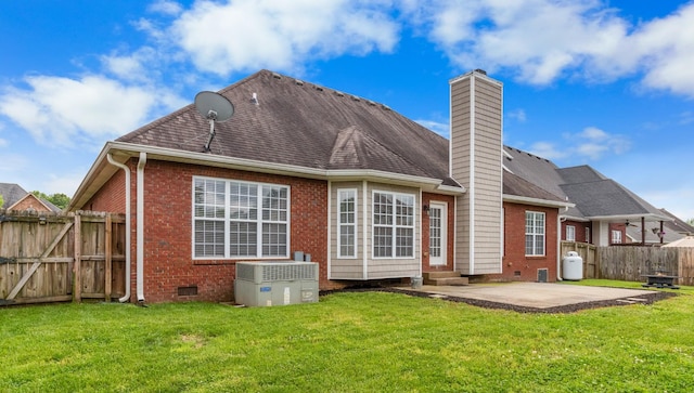 back of house with a yard, cooling unit, and a patio area