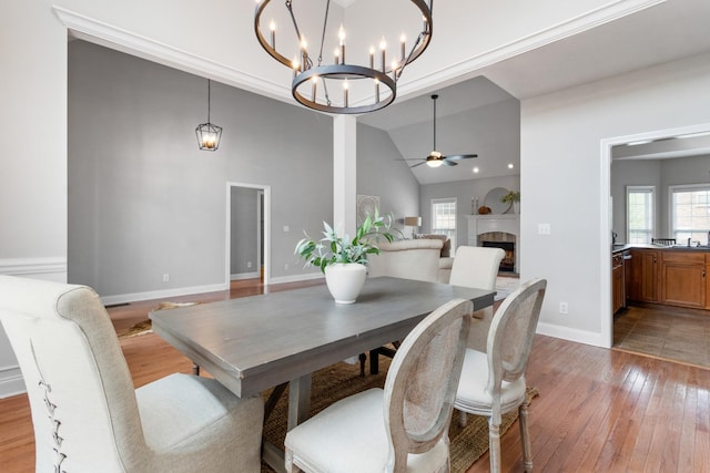 dining space featuring a healthy amount of sunlight, ceiling fan, lofted ceiling, and light hardwood / wood-style floors